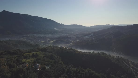Mystic Fog over a Mysterious Town over the Hills alt
