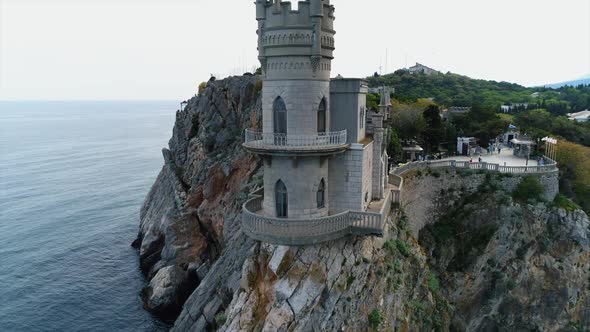 Aerial View of Swallow Nest Castle in Yalta, Crimea. Flying Over Rocky Blue Sea Shore alt
