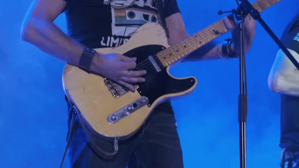 Guitarist at a Rock Concert Plays Electric Guitar on the Open Stage. Slow Motion alt