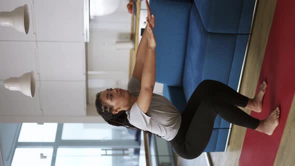 African American Young Sportswoman Doing Squats on a Mat at Home alt