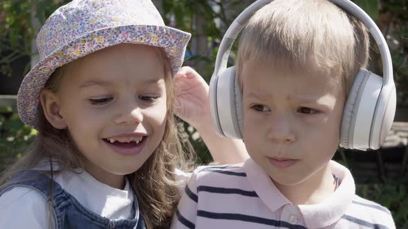 Portrait of Cute Little Two Children With Headphones Listening to Music