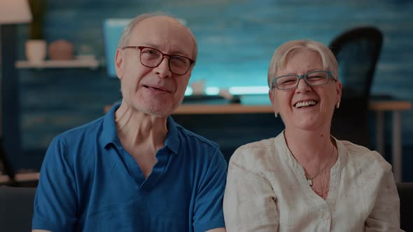Portrait of Cheerful Grandparents Laughing in Front of Camera alt