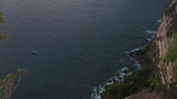 Top of the Hill of Calm Sea Waters and Rocky Shore with Waves Crashing alt