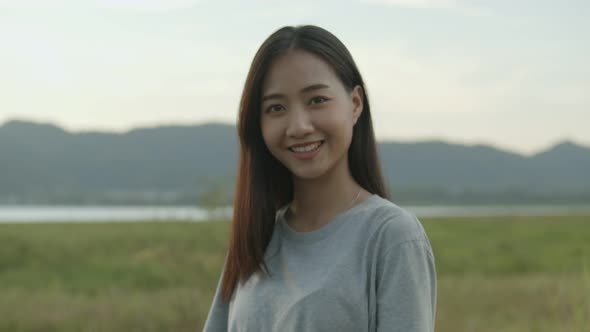 Portrait of beautiful young Asian woman smiling look at camera.