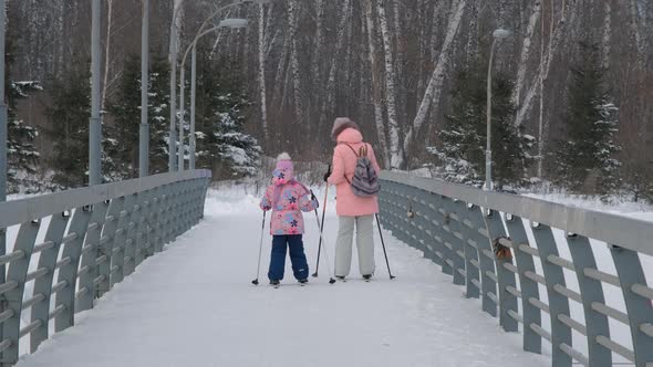 Mother Teaching Daughter To Ski in Winter Park alt