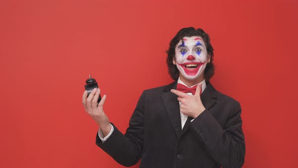 A Clown in a Black Suit with Colorful Makeup on His Face and an Alarm Clock in His Hands Had a Dream