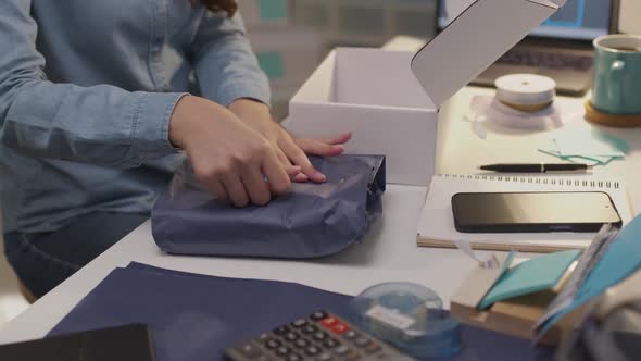 Asian small business owner woman entrepreneur work packing delivery. alt