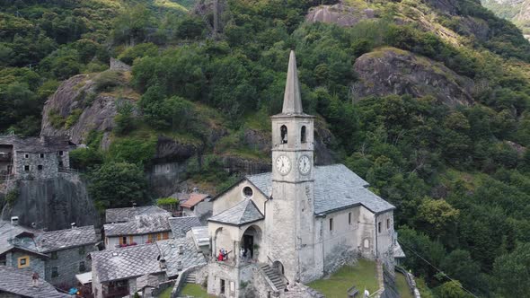 Zooming Out Panoramic View of Old Church Castle Standing in Scenic Mountainous Background