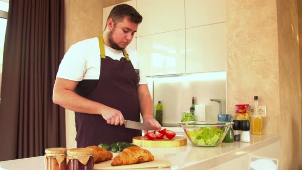 Man Cutting Fresh Tomatoes for Salad