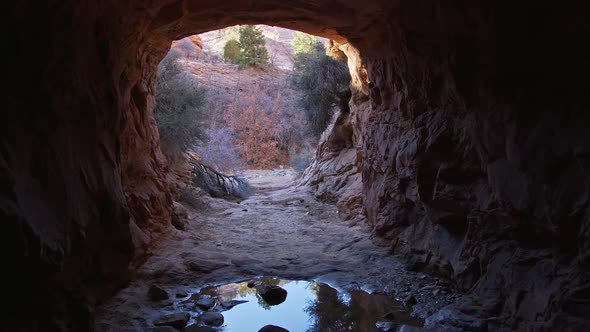 Tunnel carved in sandstone in the Utah desert for water to move under the road alt