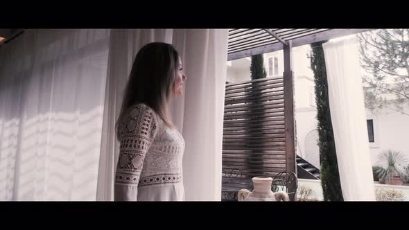 Woman Looking through a window alt