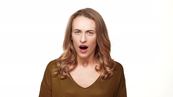 Angry Caucasian Middleaged Female with Long Brown Hair Screaming on White Background alt