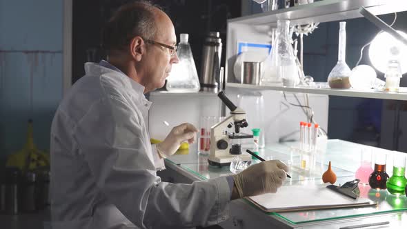 Male Scientist Working in Modern Lab Making Research and Studying alt