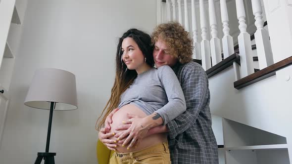 Husband and Pregnant Wife with Dreadlocks which Enjoying Future Parenthood when Their Baby Will Born alt