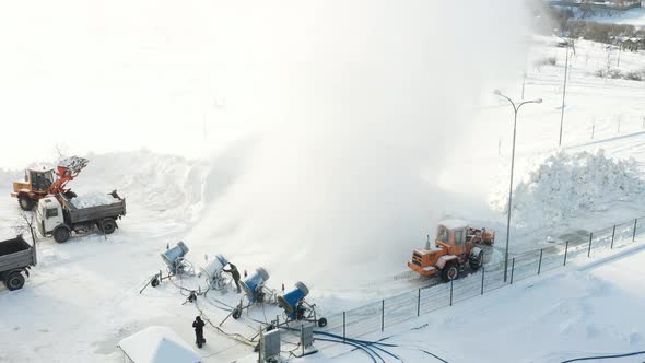 Top view of the work of four snow cannons for the production of artificial snow alt