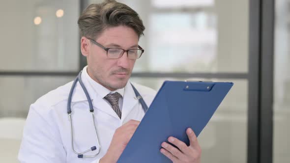 Portrait of Doctor Checking Medical Reports alt