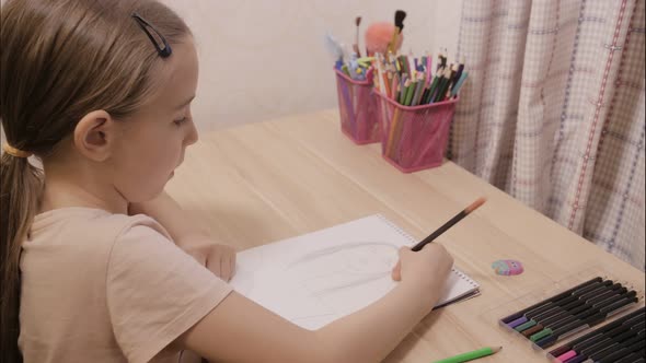 A Cute Girl Indoors At Home, Drawing Portrait of Mom. Timelapse Video