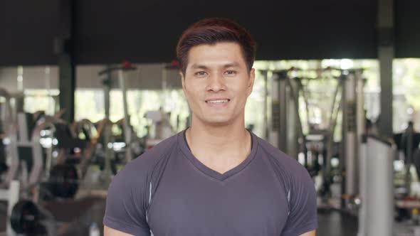 Asian healthy sport man trainer with sportswear smile looking at camera feel cheerful and fresh.