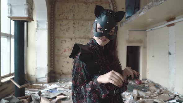 Young Beautiful Girl Stands on a Drum Among the Garbage in a Ruined Building alt