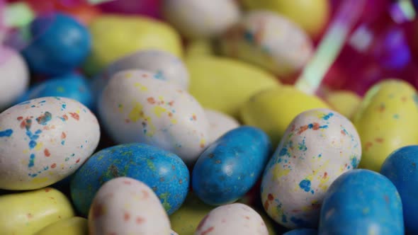 Rotating shot of colorful Easter candies on a bed of easter grass  alt