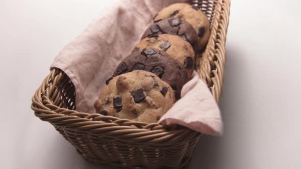 Yummy Chocolate Chip Cookies in Wicker Basket, White Background alt