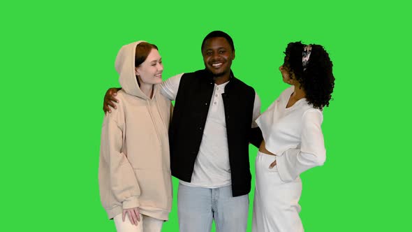 Young Multiethnic Friends Smiling To Camera on a Green Screen, Chroma Key. alt