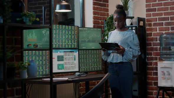 Financial Analyst Monitoring Forex Exchange Trade on Digital Tablet alt