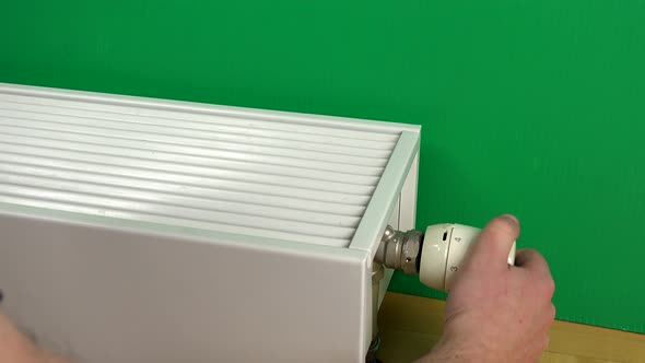 Male Man Arms Increase Radiator Temperature and Warm Hands on It.