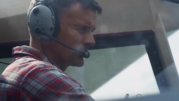Portrait Professional Aviator Headset in Aircraft Cockpit Analyzing Plane alt