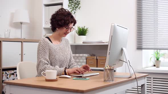 Young Blogger at Work Typing her New Post alt