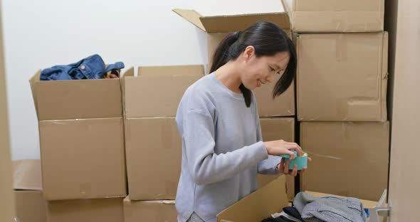 Woman find something inside cardboard box