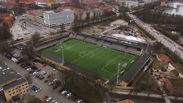 People training on soccer field at Malmo, Sweden. Aerial top-down circling alt