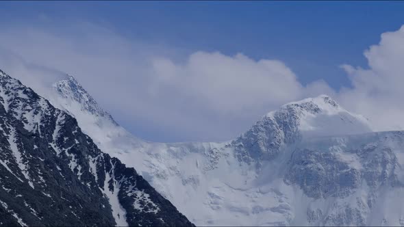 Timelapse of the Two Peaks of the Russian Mountain Belukha in the Clouds Floating in the Sky