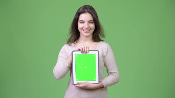 Young Happy Beautiful Woman Smiling While Showing Digital Tablet alt