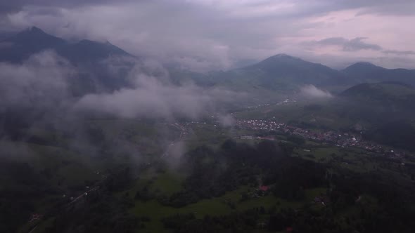 Flying Over Misty Mountains and Hills in the Countryside