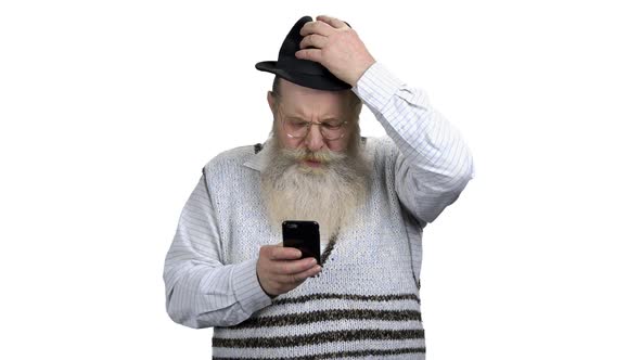 Portrait of Senior Man Surfing Internet on Mobile Phone alt