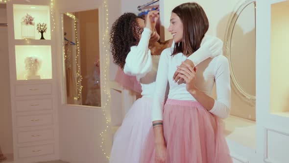 Two young beautiful smiling international hipster female in trendy summer dresses alt