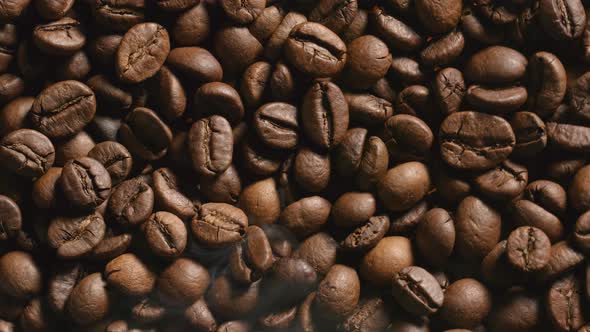 Close Up of Roasted coffee beans with a smoke