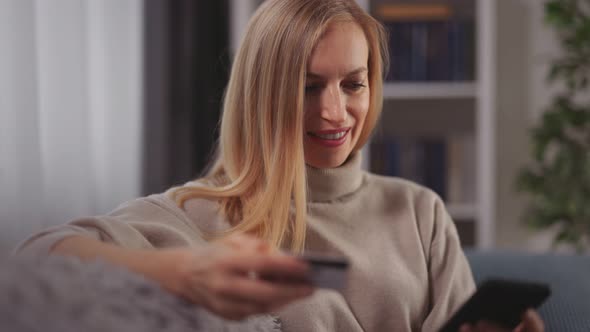 Woman Using Credit Card and Mobile alt