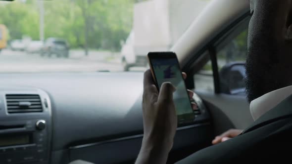 Afro-American Man Riding in Taxi for Interview, Nervously Scrolling Web Pages
