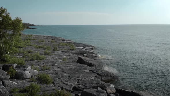 Cinematic view from drone flying the intense blue water in Meldrum Bay
