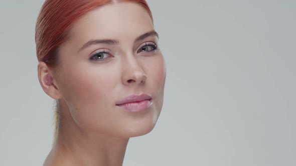 Studio portrait of young, beautiful and natural redhead woman. Beauty concept. alt