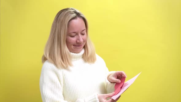 Happy Young Women Get Pink Envelope with Pink Paper Heart alt