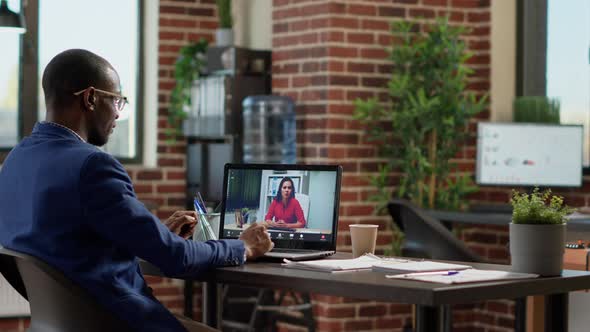 African American Worker Meeting with Businesswoman on Online Video Call alt