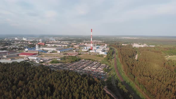 Industrial Area of City with Factories and High Pipe Near Railway Aerial View alt