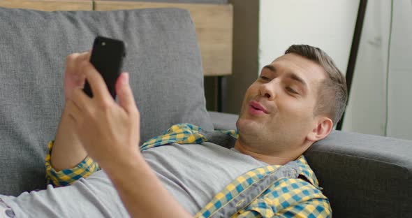 Handsome Man Has a Conversation Via Video Application alt