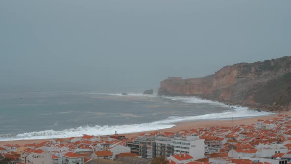Nazare Coast Scene with Oceanfront Hotels and Lighthouse on the Rock Portugal alt