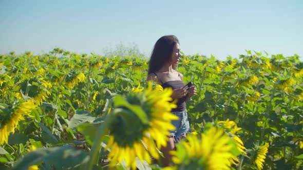 Happy Female Taking Selfie in Blossoming Farmland alt