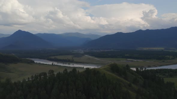Aerial of majestic river Katun and valley of Altai under sunset sky