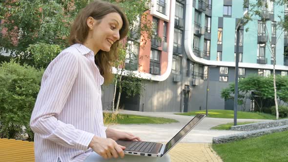 Young Woman is Having Online Meeting Using Her Laptop Businesswoman with Digital Tablet Outside on alt